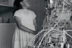 Marisa Murray looking at a Christmas tree display in a Tauranga store, December 1965.