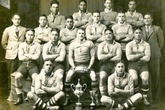 Matakana rugby team photographed in Tauranga, with trophies and season match results.