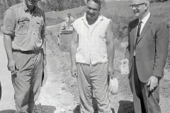 C. Kuka, W. Gardiner and Mr Watt discussing Kaimai Highway maintenance, 1969.