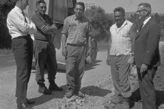 .O.W. staff discussing maintenance problems and solutions on the Kaimai Highway, 1969.